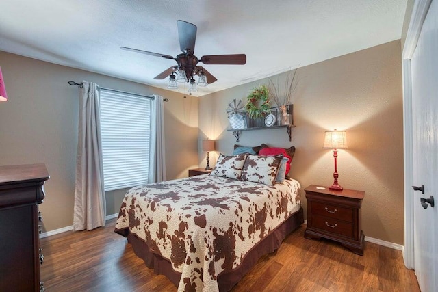 bedroom with dark wood-type flooring and ceiling fan