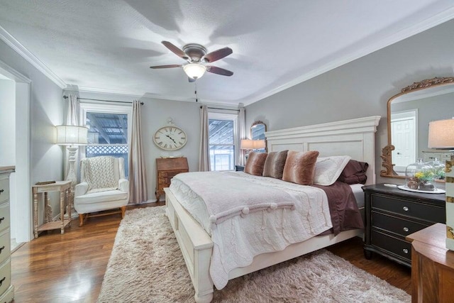 bedroom with ceiling fan, crown molding, and dark hardwood / wood-style floors