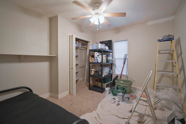 carpeted bedroom with a closet and ceiling fan