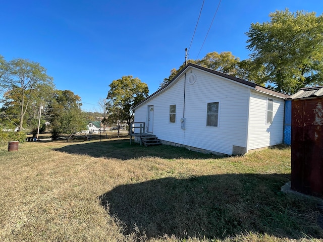 view of side of property featuring a yard