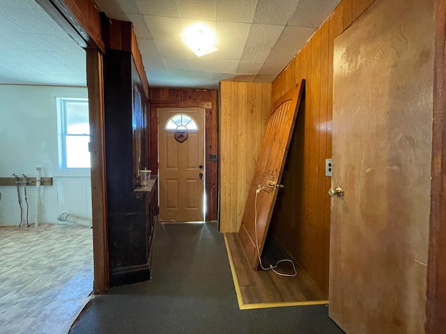 doorway to outside featuring wooden walls