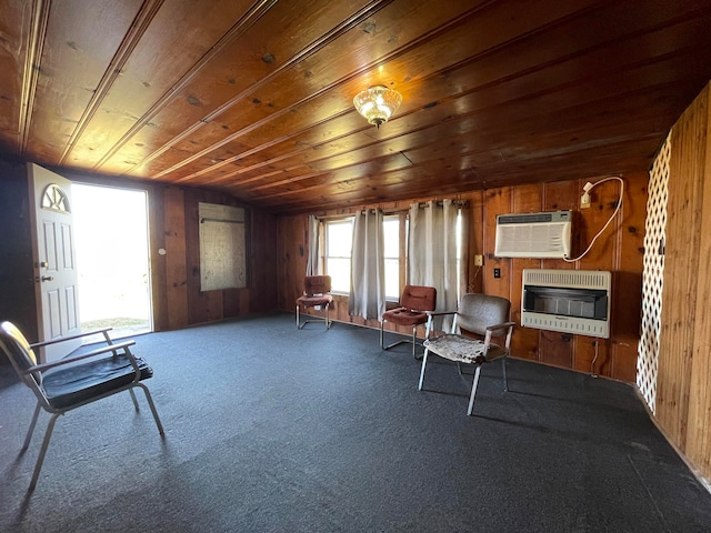 living area with wood walls, carpet flooring, a wall mounted air conditioner, wooden ceiling, and heating unit