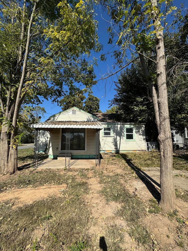 view of property exterior with a patio area