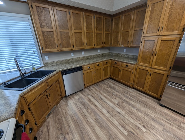 kitchen with dishwasher, sink, light wood-type flooring, and white range oven