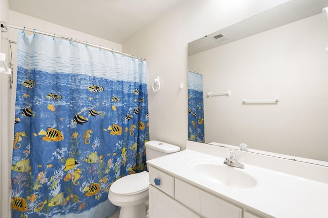 bathroom with vanity, toilet, and walk in shower