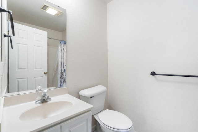 bathroom with vanity, toilet, and a shower with curtain