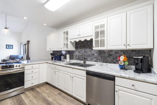 kitchen with sink, white cabinetry, light hardwood / wood-style flooring, and stainless steel appliances