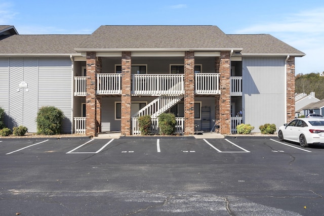 123 River Point Rd Unit 37, Hollister, MO 65672 - view of building exterior featuring uncovered parking and stairs