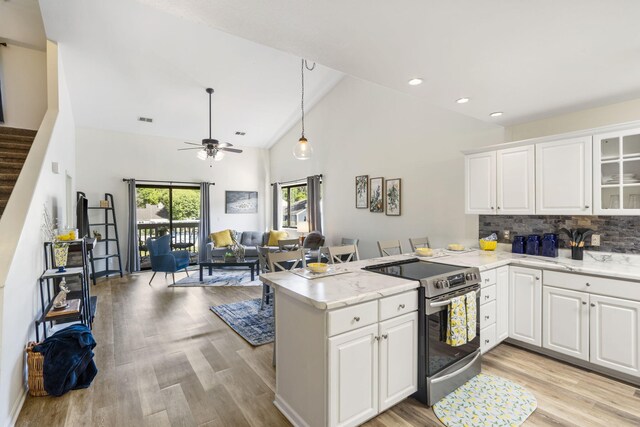 123 River Point Rd Unit 37, Hollister, MO 65672 - kitchen with stainless steel range with electric stovetop, a peninsula, light wood finished floors, white cabinetry, and decorative backsplash
