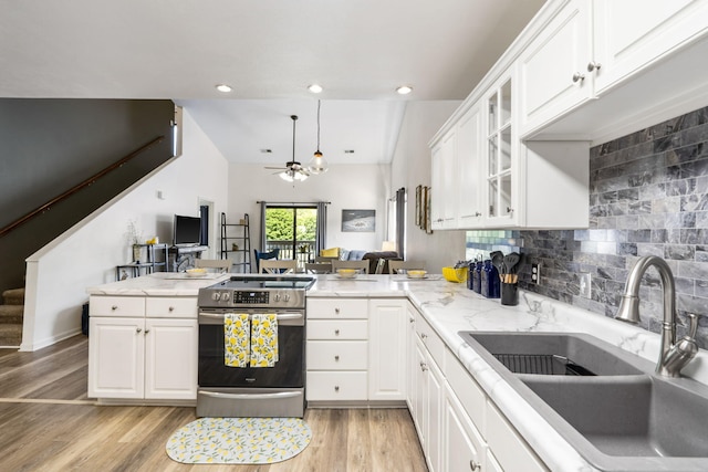 123 River Point Rd Unit 37, Hollister, MO 65672 - kitchen featuring a sink, stainless steel electric range oven, a peninsula, white cabinetry, and glass insert cabinets