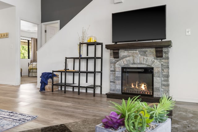 123 River Point Rd Unit 37, Hollister, MO 65672 - living room with wood finished floors, a stone fireplace, and baseboards