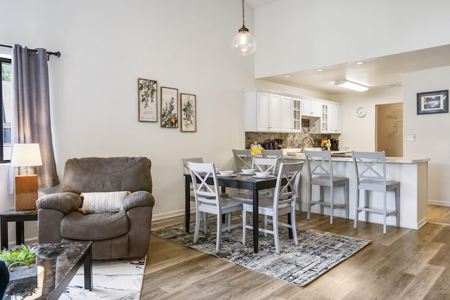123 River Point Rd Unit 37, Hollister, MO 65672 - dining space featuring light wood finished floors, baseboards, and a high ceiling