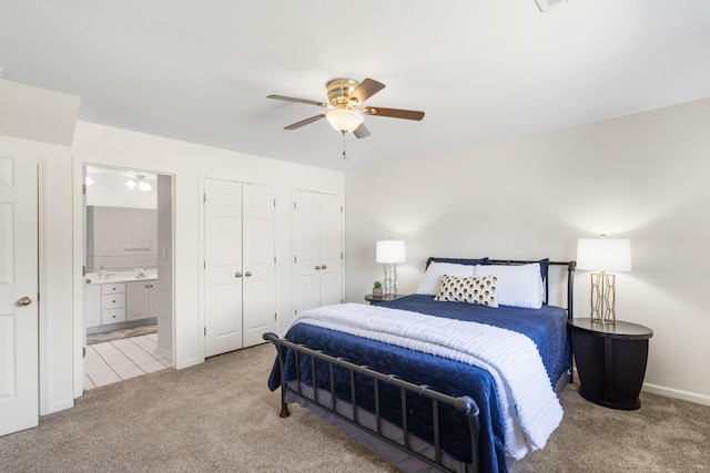 123 River Point Rd Unit 37, Hollister, MO 65672 - carpeted bedroom with two closets, connected bathroom, baseboards, and ceiling fan