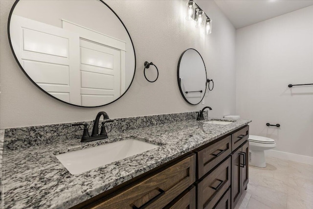 bathroom featuring toilet and vanity