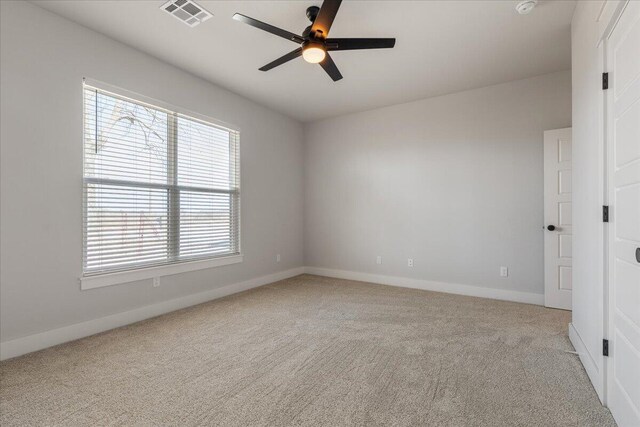 unfurnished room with ceiling fan and light colored carpet