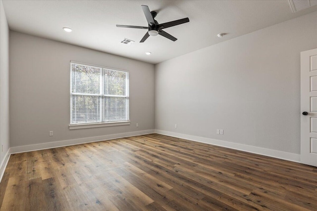 spare room with dark wood-type flooring and ceiling fan