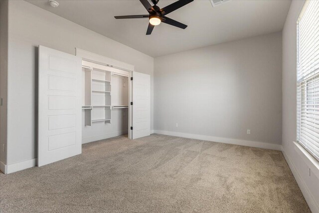 unfurnished bedroom with carpet flooring, a closet, and ceiling fan