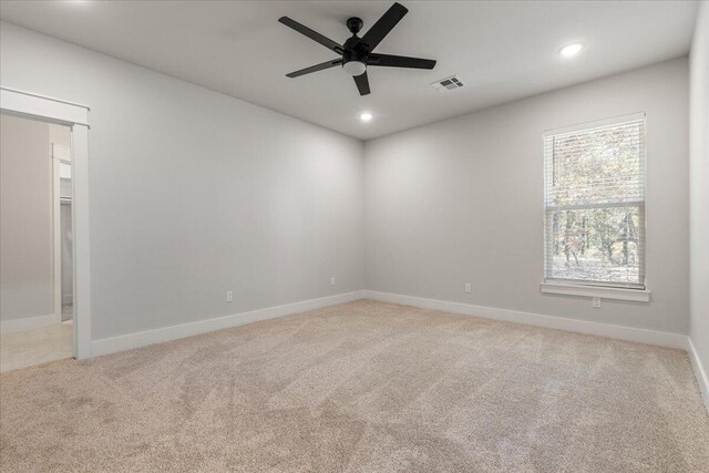 empty room with light carpet and ceiling fan