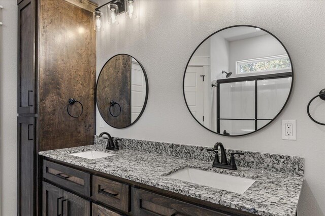 bathroom with vanity and a shower with shower door