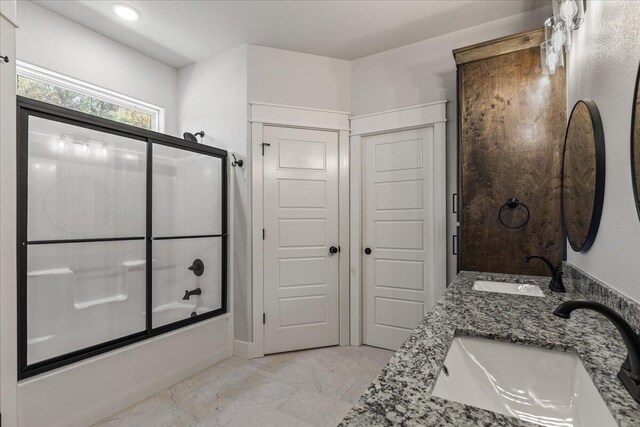 bathroom with vanity and enclosed tub / shower combo