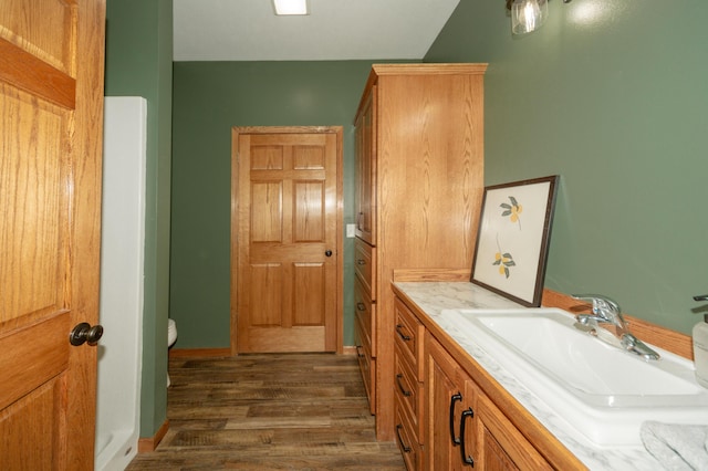 322 W Jefferson St, Bolivar, MO 65613 - bathroom with wood finished floors, vanity, and toilet