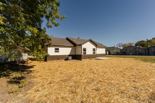 back of house featuring central AC unit