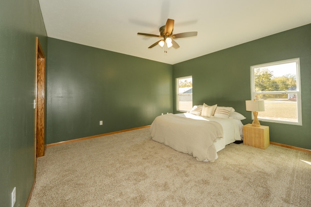 bedroom with ceiling fan and light colored carpet