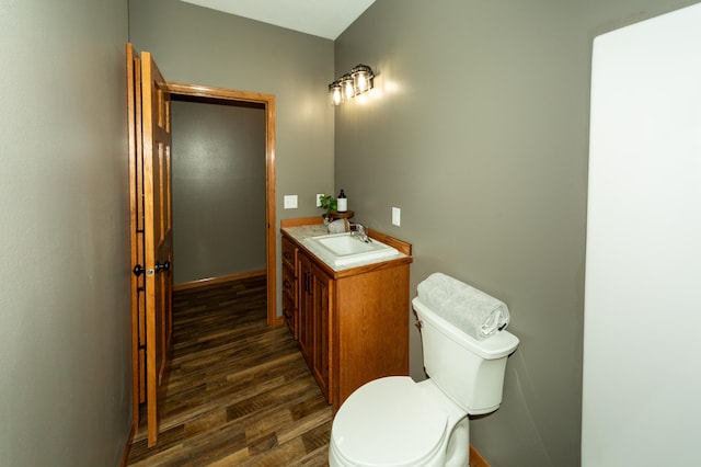 bathroom with vanity, toilet, and wood-type flooring