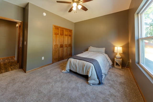 carpeted bedroom featuring a closet and ceiling fan