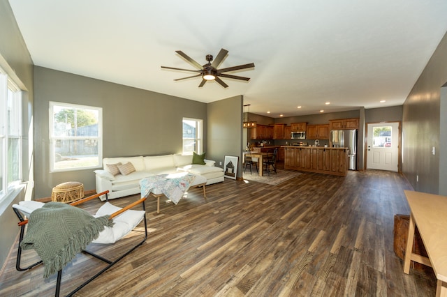 living room featuring ceiling fan and dark hardwood / wood-style flooring