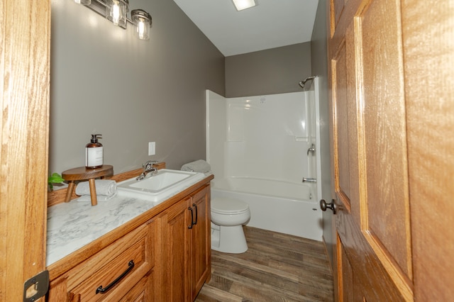 full bathroom with vanity, hardwood / wood-style flooring, toilet, and shower / bathtub combination