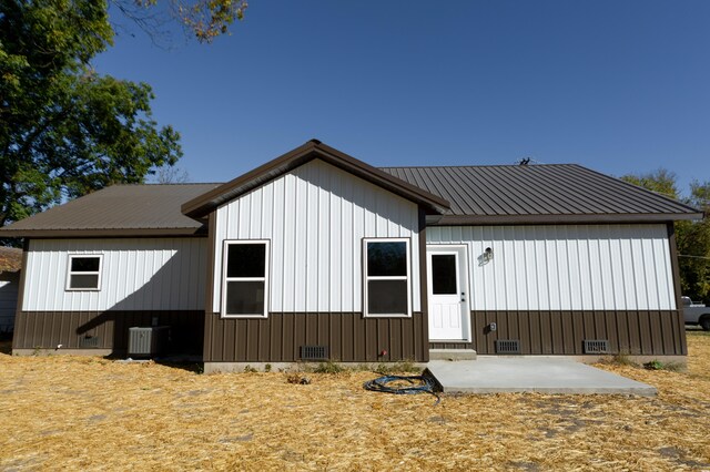 back of house featuring central air condition unit and a patio area