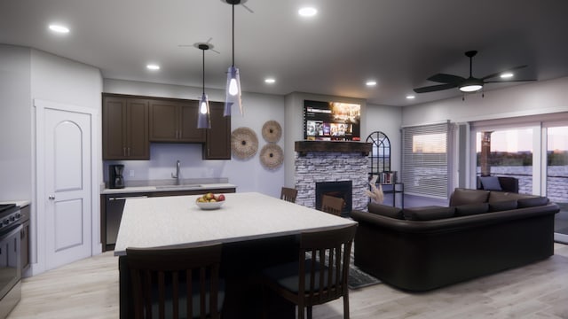 kitchen with open floor plan, light wood finished floors, dishwasher, and light countertops