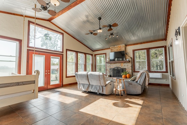 living room featuring tile patterned floors, french doors, a fireplace, high vaulted ceiling, and ceiling fan