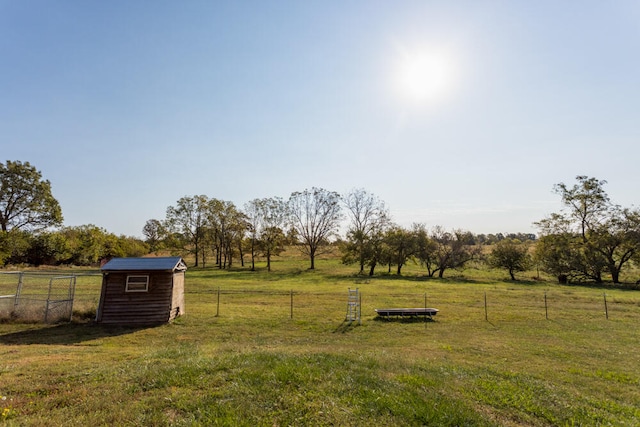 view of yard featuring a storage shed and a rural view