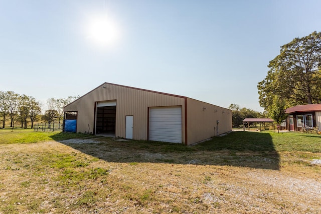 view of outdoor structure with a yard and a garage