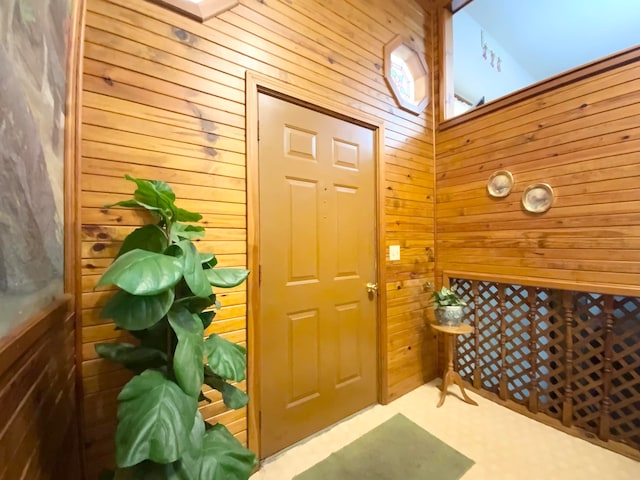 interior space with a high ceiling and wooden walls