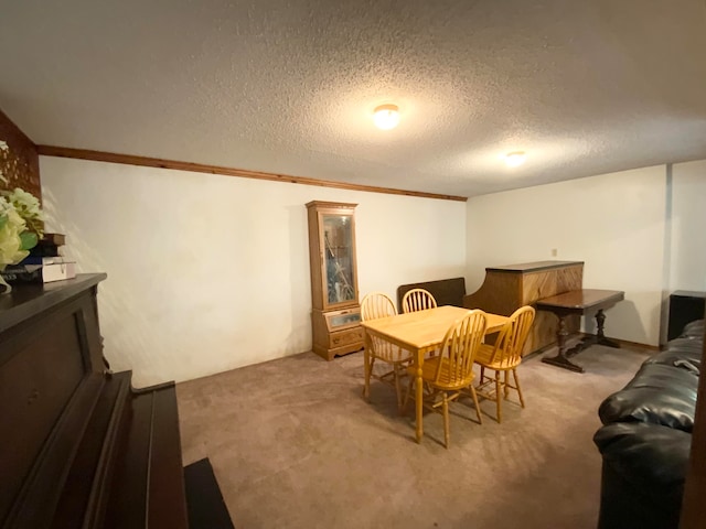 carpeted dining space featuring crown molding and a textured ceiling