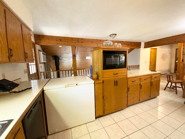 kitchen with wooden walls, kitchen peninsula, a wood stove, black appliances, and light tile patterned flooring