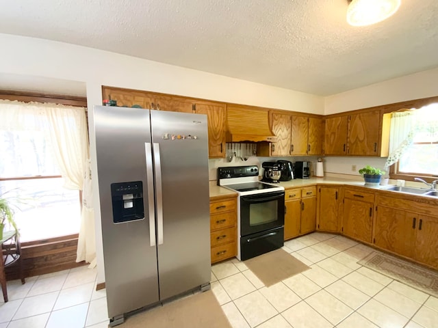 kitchen featuring light tile patterned flooring, black electric range, sink, and stainless steel fridge with ice dispenser