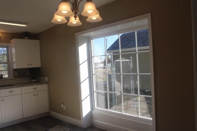 unfurnished dining area with sink and an inviting chandelier