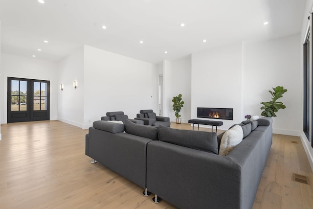 living room featuring french doors and light hardwood / wood-style floors