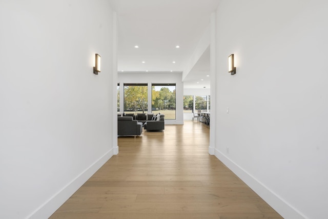 hallway with light hardwood / wood-style floors