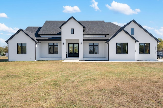 rear view of property with a lawn