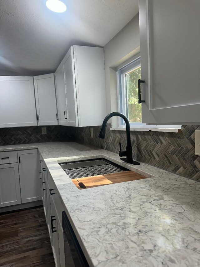 320 W N St, Mountain Grove, MO 65711 - kitchen with a sink, tasteful backsplash, dishwasher, dark wood-type flooring, and white cabinetry