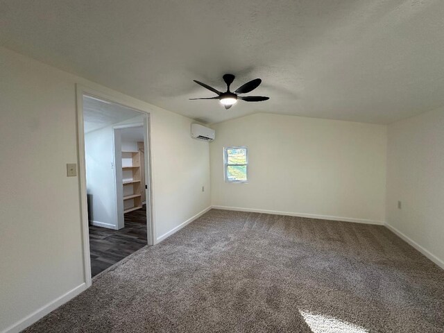 320 W N St, Mountain Grove, MO 65711 - spare room with an AC wall unit, carpet flooring, ceiling fan, baseboards, and lofted ceiling