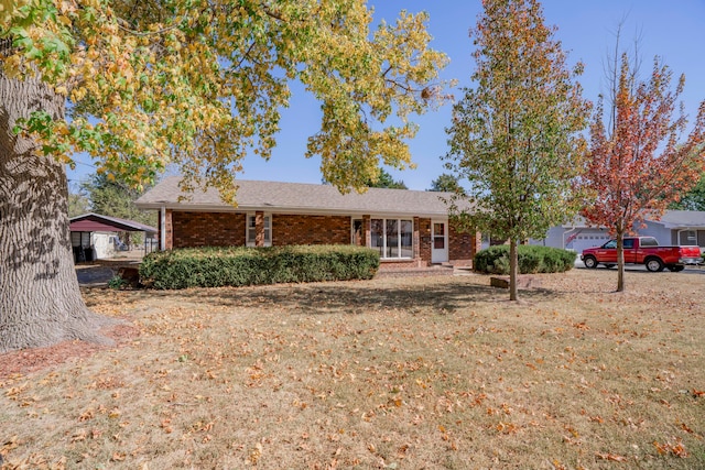 ranch-style house featuring a front yard and a carport