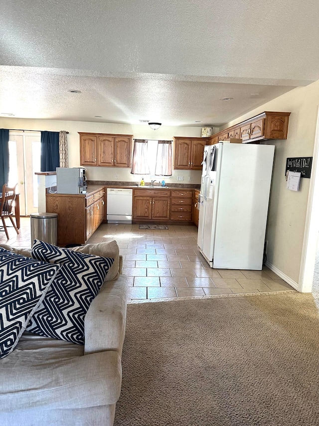 tiled living room with sink and a textured ceiling