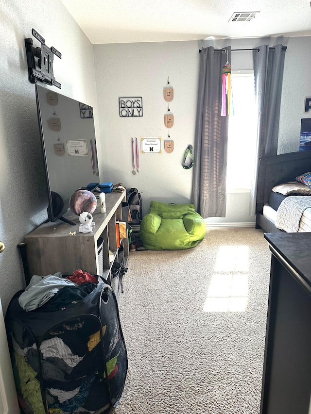 bedroom featuring carpet and a textured ceiling