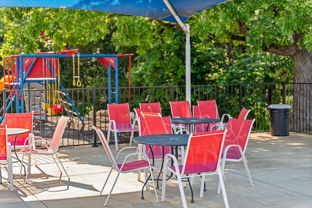 view of patio with fence and playground community